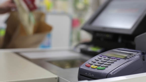 Girl is Shopping, Paying by Credit Card