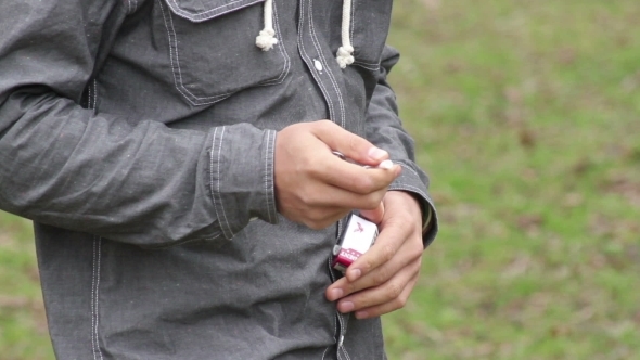 Man With Beard And Glasses Smoking A Cigarette