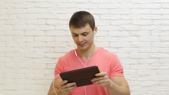 Casual Man Play Video Games Using Tablet Computer Application
