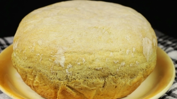 Homemade Bread On The Table Rotates On a Black Background
