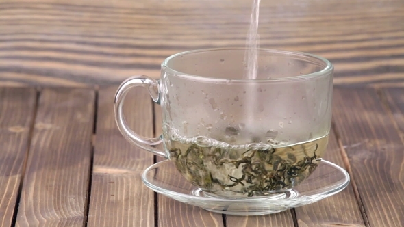 Tea Being Poured Into Glass Tea Cup