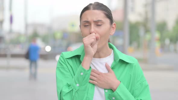 Hispanic Woman Coughing While Standing Outdoor