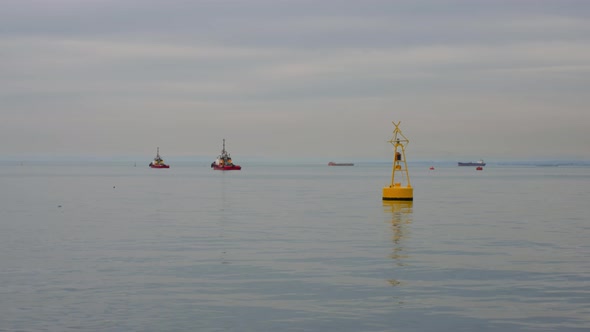 Static Shot Yellow Buoy in Port on the Background a Tug Boats