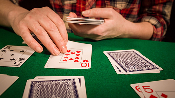 Female Hands Holding Cards And Playing Solitaire