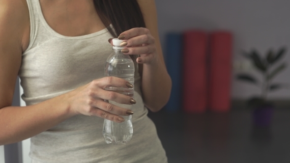 Woman In Gym Drinking Water