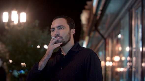 Man Smoking At Night City