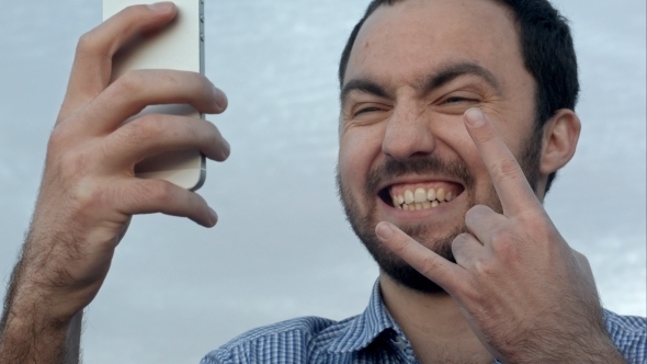 Smile Man  Take a Selfieusing His Smartphone Device