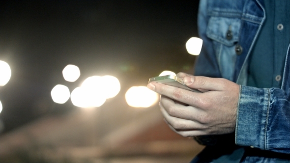 A Man Send Message By Smartphone At City Night