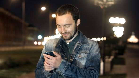 Young Male In The City Using His Smartphone.