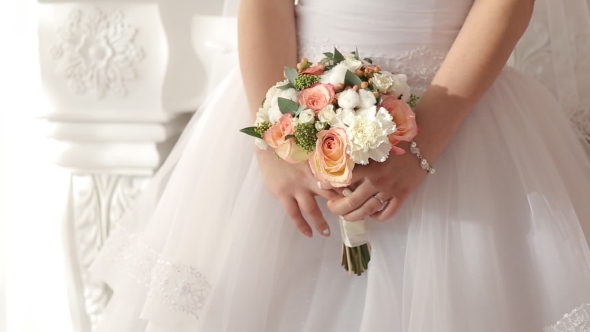 The Bride Holds a Wedding Bouquet