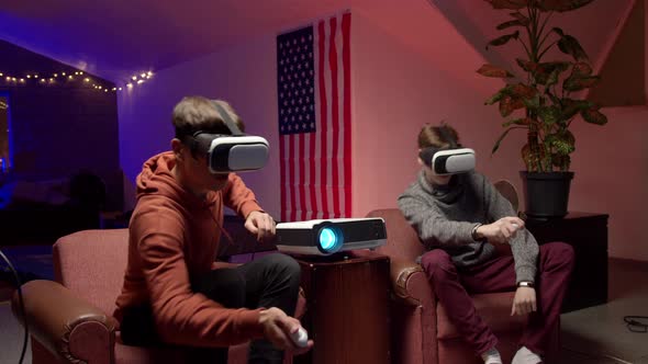 Young Men in Headsets Playing Virtual Videogame Together