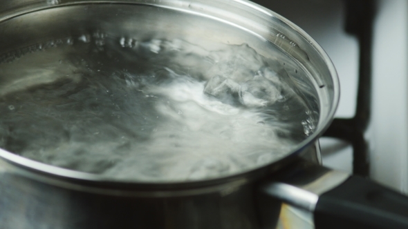 Boiling Water In a Pot Bubbling Over