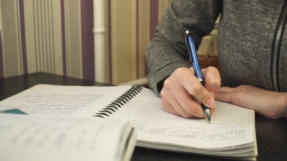 The Student Writes In a Notebook alt