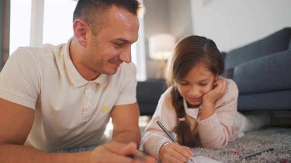 Father and Daughter Communicate Having Fun and Painting Together