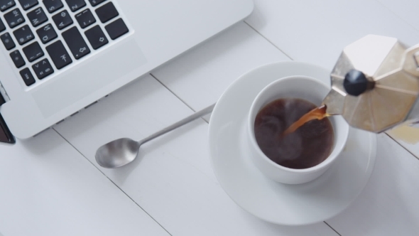 Hand  Pouring Coffee In a Cup