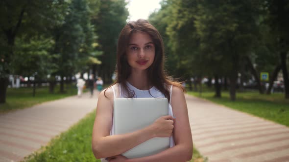 Portrait of Beautiful Brunette Student Woman Outdoor in the Summer, Looking and Smiling Close-up