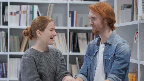 Happy Man and Woman Doing Promise Gesture in Office