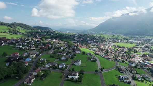 Aerial View of Liechtenstein with Houses on Green Fields in Alps Mountain Valley