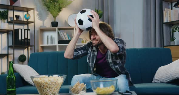 Guy Rejoicing from Scored Goal with Shouts when Watching Football Match on TV at home