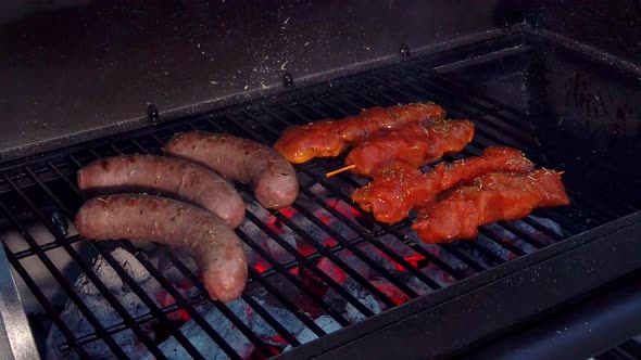 Looking at the Sausages and Chicken Sate getting the heat and smoke of the BBQ