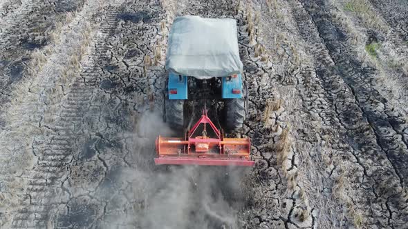 Tractor plowing in farm