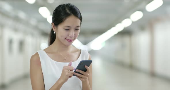 Woman look at mobile phone in city