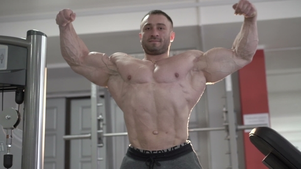 The World Champion Of Bodybuilding Posing In The Gym