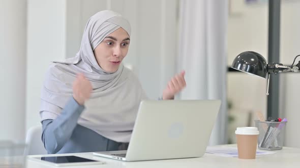 Successful Young Arab Woman Celebrating on Laptop in Office