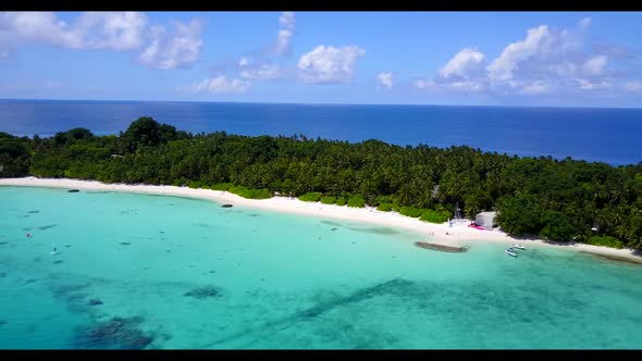 Aerial view scenery of tranquil seashore beach lifestyle by aqua blue ocean with white sandy backgro