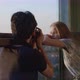 Model looking at phototgrapher on balcony - VideoHive Item for Sale