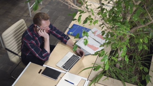 Bearded Man Gets The Job Over The Phone, Kneads His Hands.