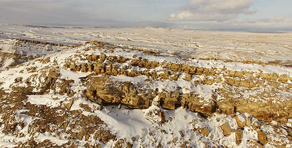 Low Flyover of Snow Covered Cliff Face