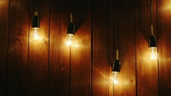 Garland Of Electric Bulbs On a Wooden Background