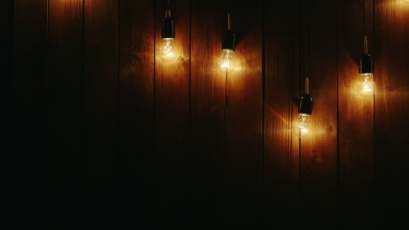 Garland Of Light Bulbs On a Wooden Background