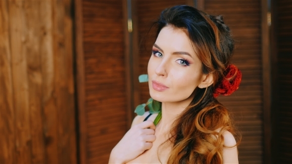 Beautiful Woman With a Flower In Her Hair