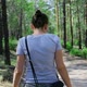The Girl Walks Alone Through the Forest on a Sunny Summer Day - VideoHive Item for Sale