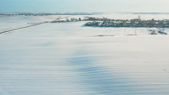 Countryside Road And Village Snowcovered Gardens And Field In Winter Day