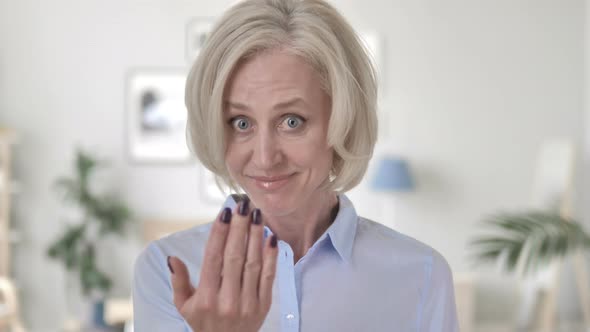 Inviting Gesture by Happy Aged Woman