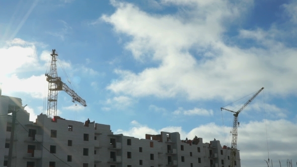 Construction Cranes Operate On Building Project