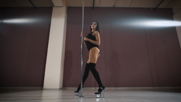 Young Slim Sexy Brunette Pole Dance Woman. 