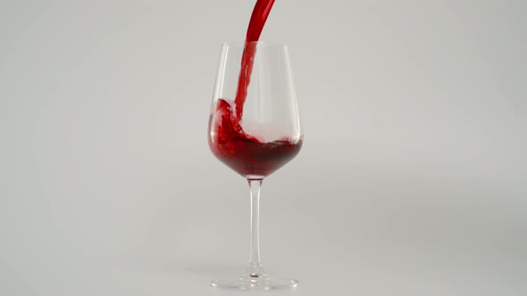 Pouring Red Wine in Glass at 1000 Fps Super Slow Motion Shot White Background