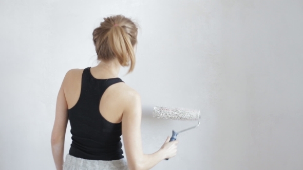Young Woman Painting Wall