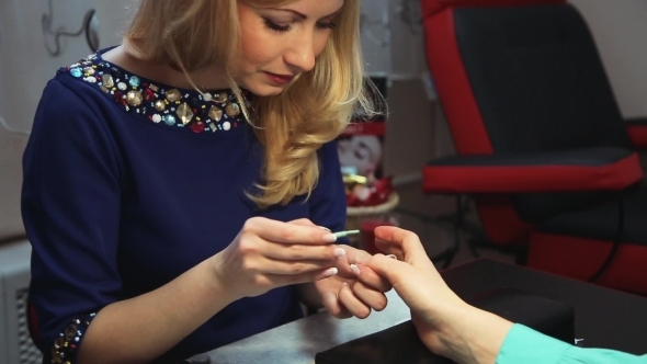 Manicurist Paints Client Nails