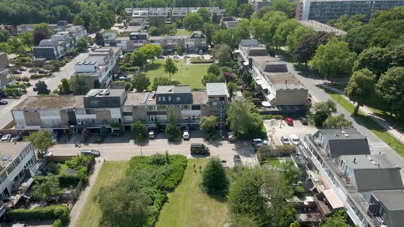 Aerial towards row of houses with one house under renovation in a green suburban neighborhood