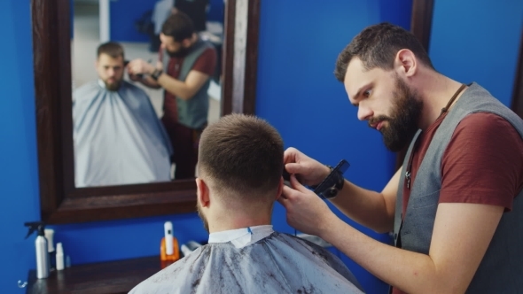 Barber Cuts The Hair Of The Client With Clipper 