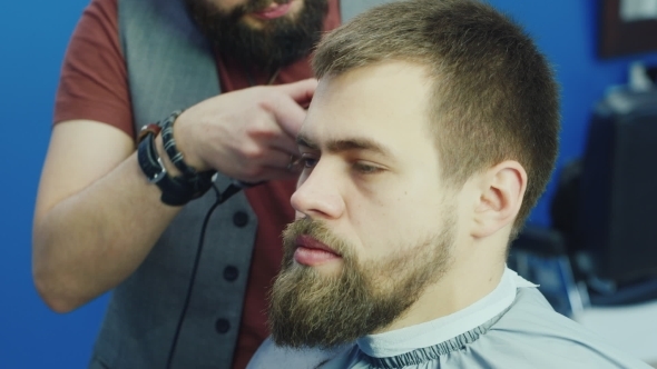 Male Barber At Work, Doing Hairstyle Young Man