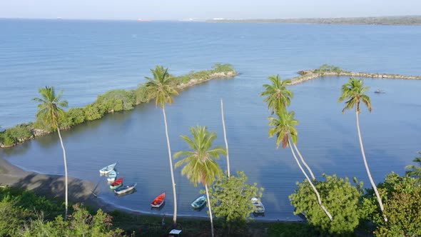 Small boats anchored on bay of Soco river mouth, Dominican Republic. Aerial panoramic view