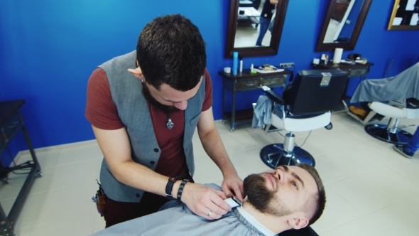 Men's Hairstyling And Haircutting In a Barber Shop Or Hair Salon. Grooming The Beard. Barbershop