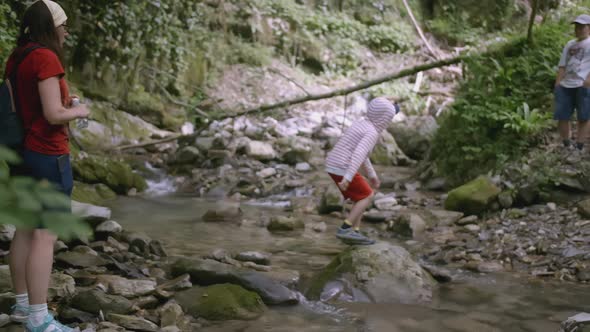 Children Walk By the River in the Forest