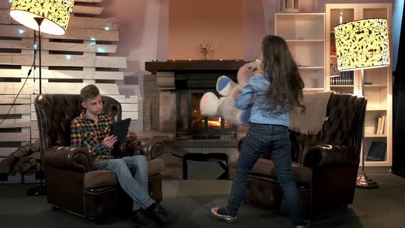 Small Girl with Big Plush Toy Asking Her Brother To Play Together